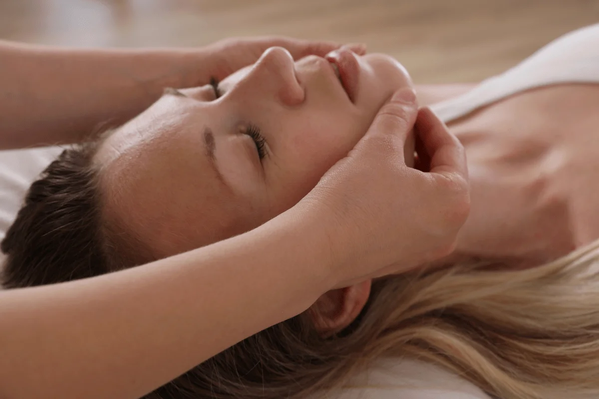 Woman receiving CranioSacral Therapy for her TJMD